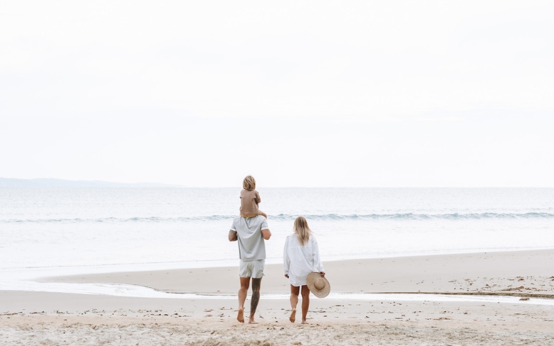 family walking on little cove beach