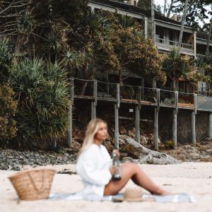 girl sitting on little cove beach